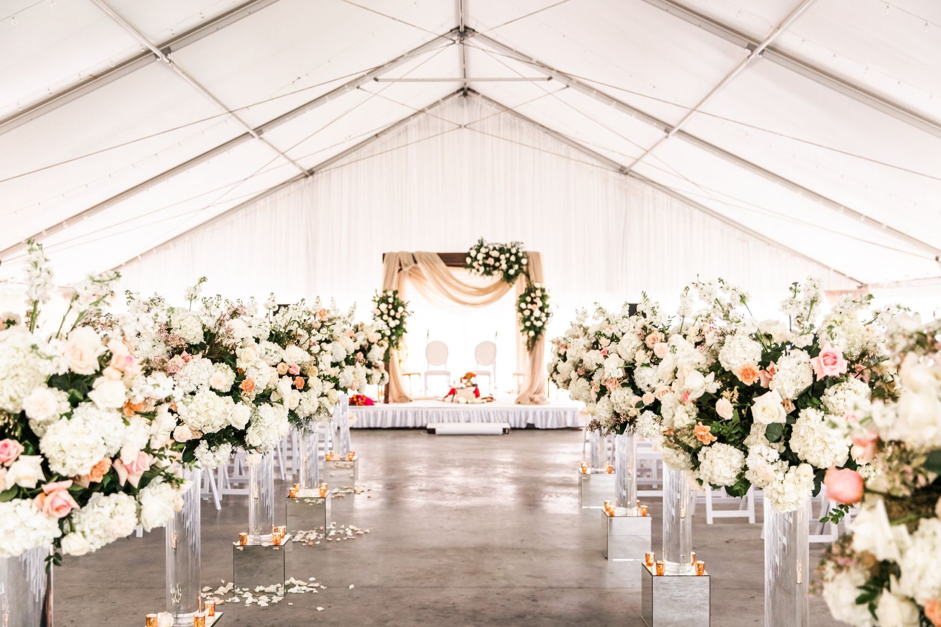 Neena and Sourav’s Wedding ceremony is taking place under a tent decorated with white flowers by Wedding Planner Nashville