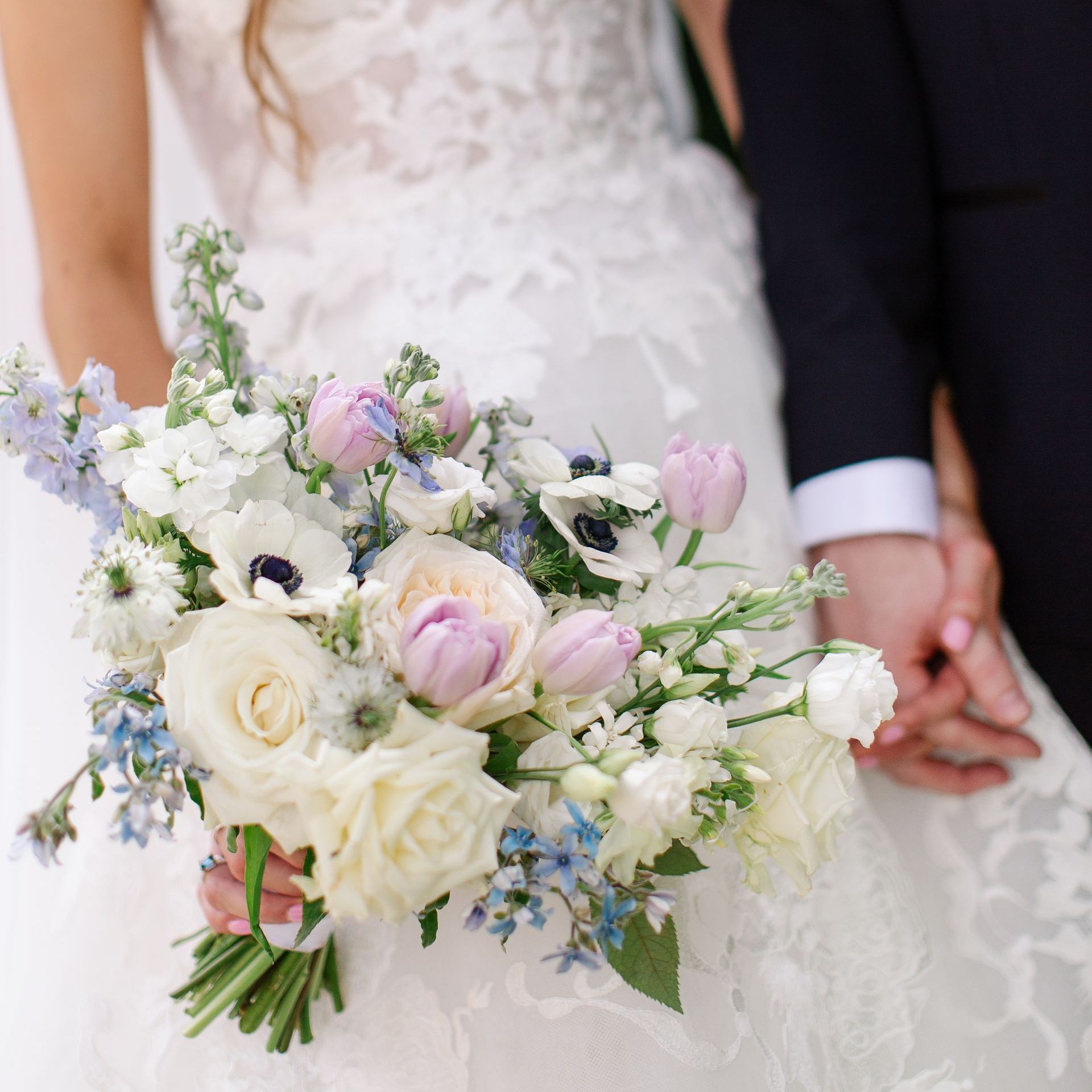 A Woman Is Standing Next to a Table Set for a Wedding Reception by Wedding Planner Nashville