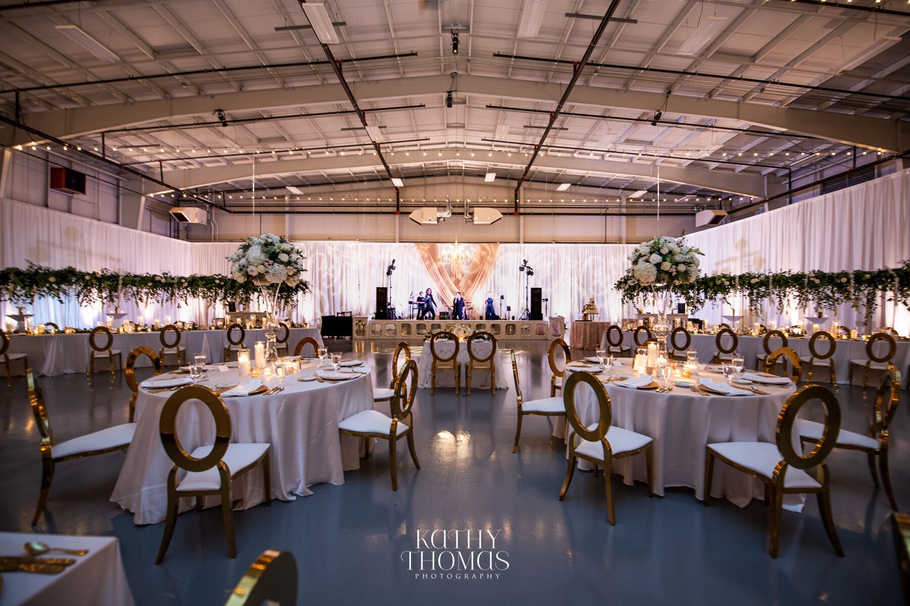 Large room with tables and chairs set up for a wedding reception by Wedding Planner Nashville