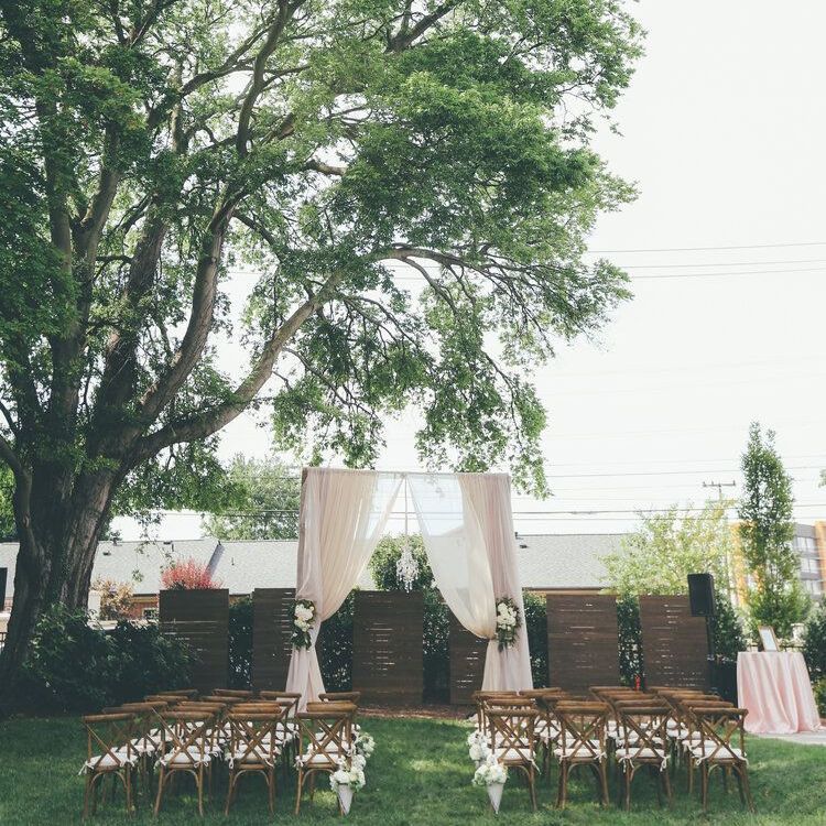 Row of chairs are lined up in front of a tree for a wedding ceremony by Wedding Planner Nashville