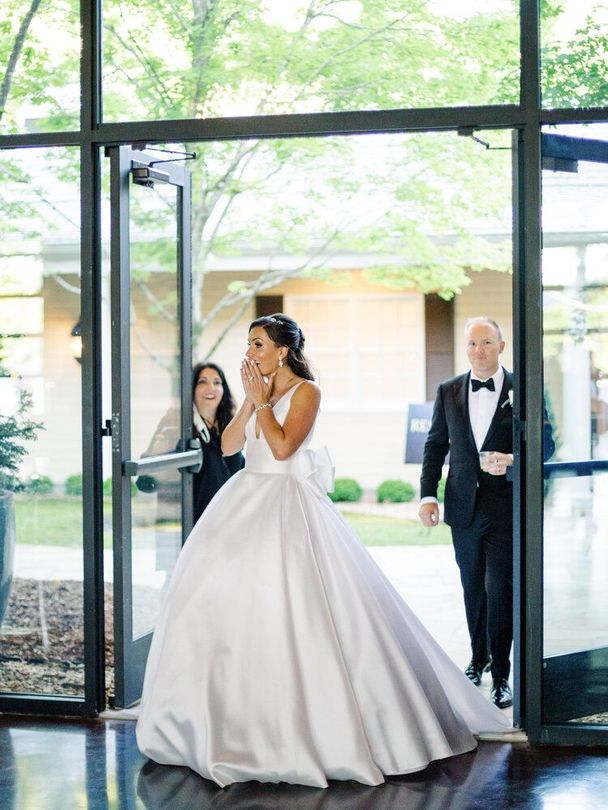 Bride in a Wedding Dress Is Walking Down the Aisle with Her Groom by Wedding Planner Nashville