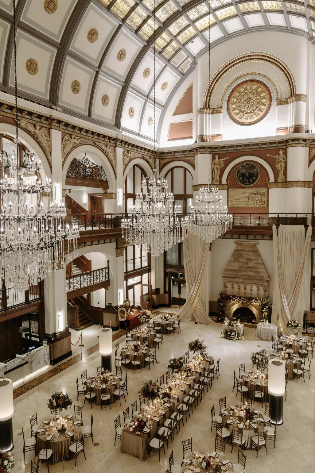Grand hall with chandeliers, tables set for a formal event by Luxury Wedding Planners in Nashville, TN