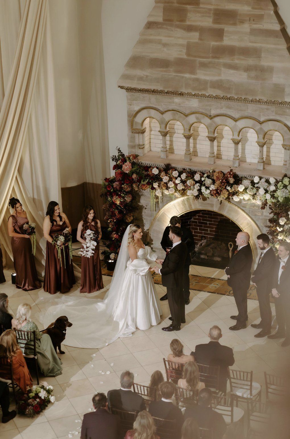 Wedding ceremony: Bride and groom at fireplace altar, flanked by Luxury Wedding Planners in Nashville, TN
