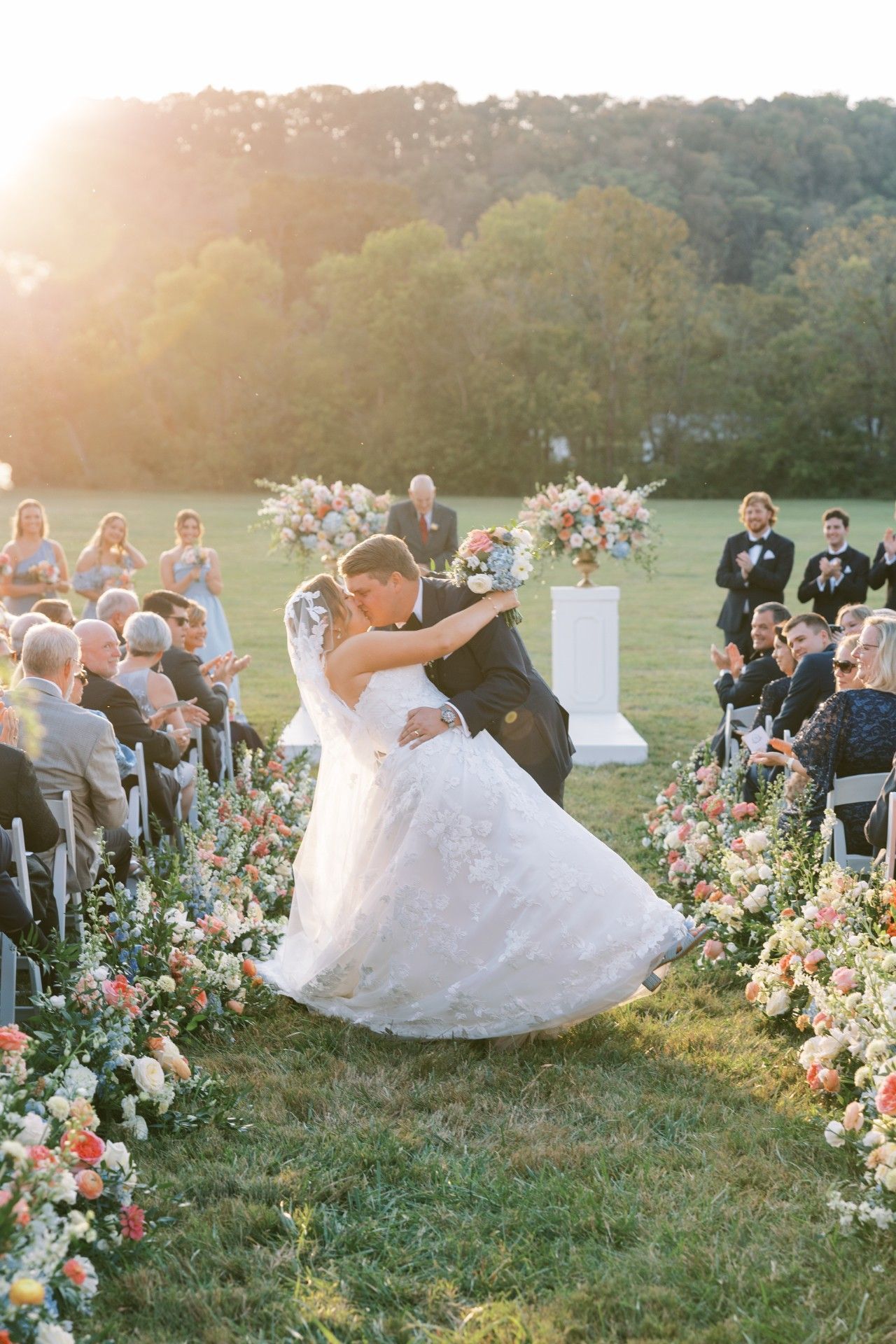 Newly Wed Dancing in The Grass at Their Wedding Ceremony by Luxury Wedding Planners in Nashville, TN