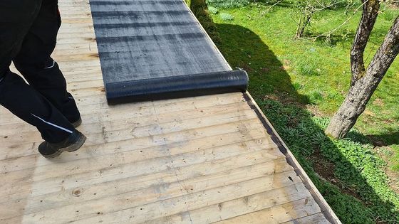 a man is standing on a wooden deck