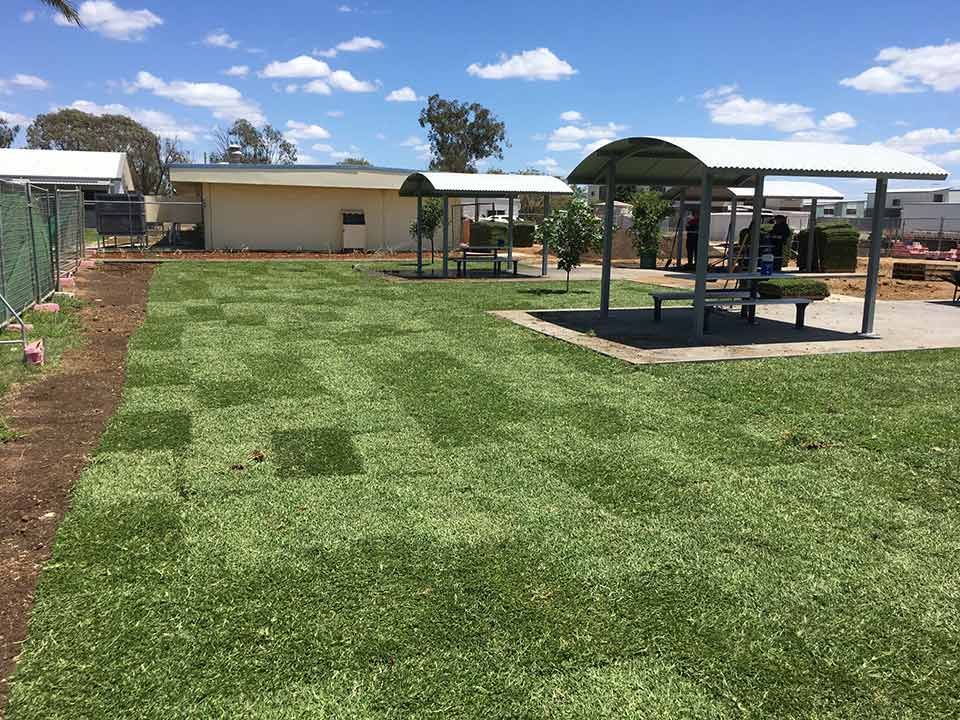 A Wooden Table Topped With Gardening Tools and a Hose — Beehive Property Maintenance in Emerald, QLD