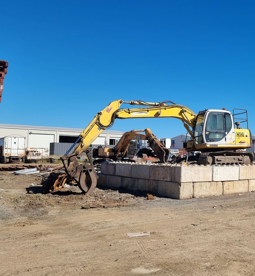 Two People Are Sweeping the Ground in Front of a Fence — Beehive Property Maintenance in Comet, QLD