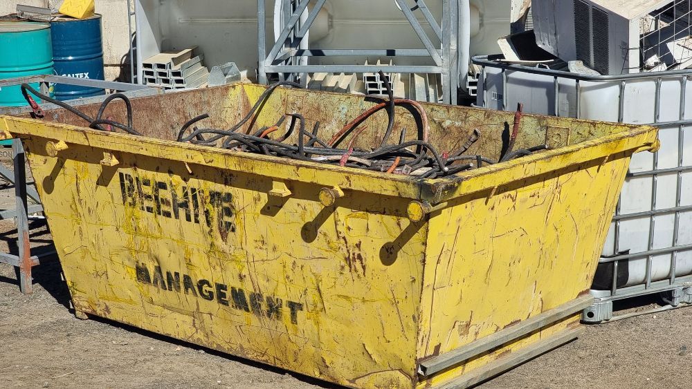 Two People Are Sweeping the Ground in Front of a Fence — Beehive Property Maintenance in Springsure, QLD