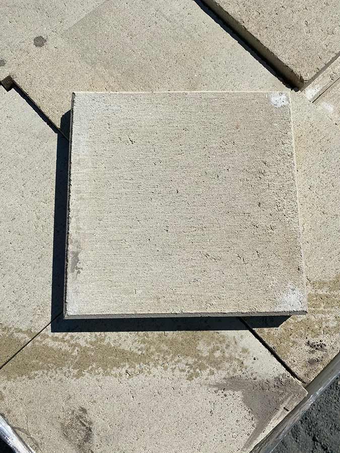 A Square Tile is Sitting on Top of a Pile of Tiles — Beehive Property Maintenance in Springsure, QLD