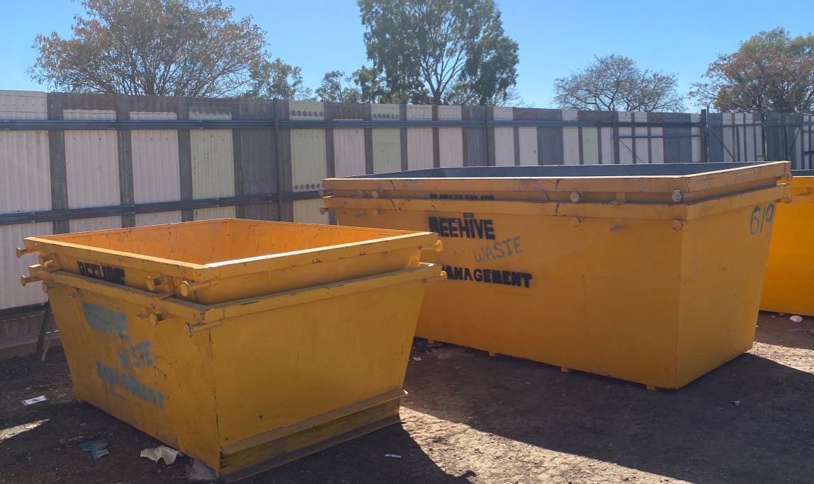 A Green Trash Can Filled With Leaves and Branches — Beehive Property Maintenance in Blackwater, QLD