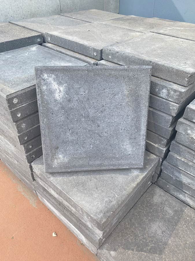 A Stack of Concrete Tiles Sitting on Top of Each Other on a Table — Beehive Property Maintenance in Emerald, QLD