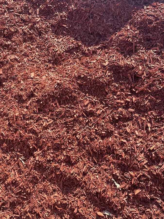 A Pile of Red Mulch is Sitting on the Ground — Beehive Property Maintenance in Clermont, QLD