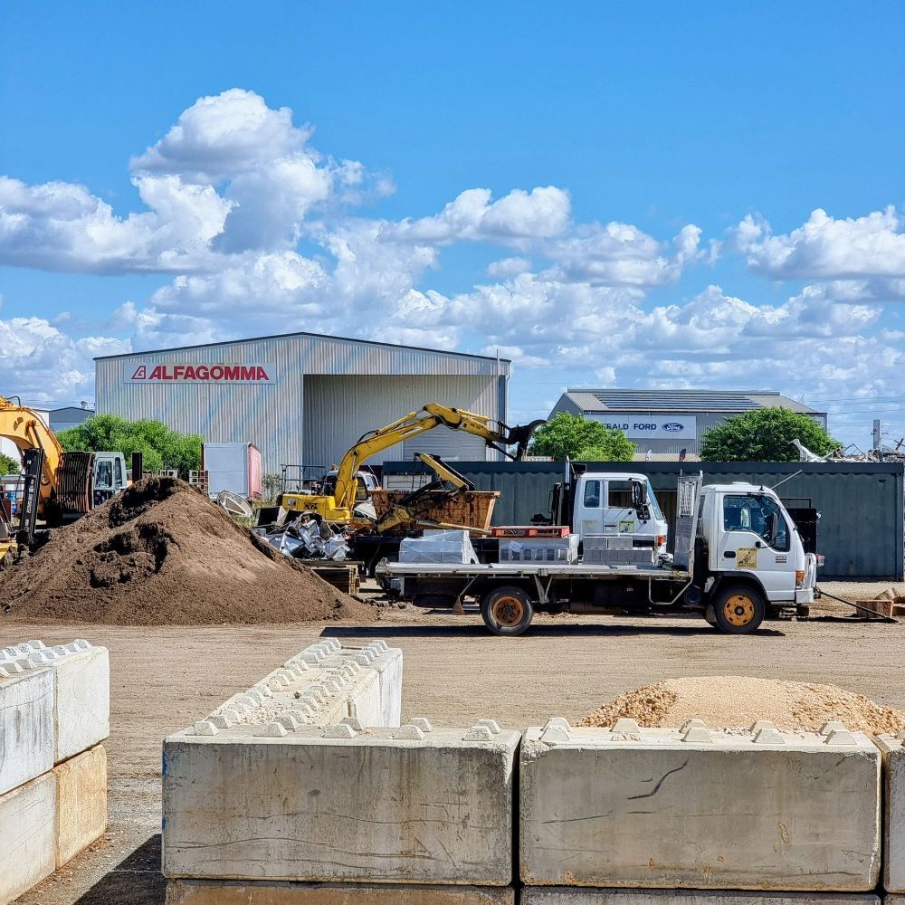 A Small Tree is Growing in the Middle of  Garden Surrounded by Trees and Mulch — Beehive Property Maintenance in Emerald, QLD