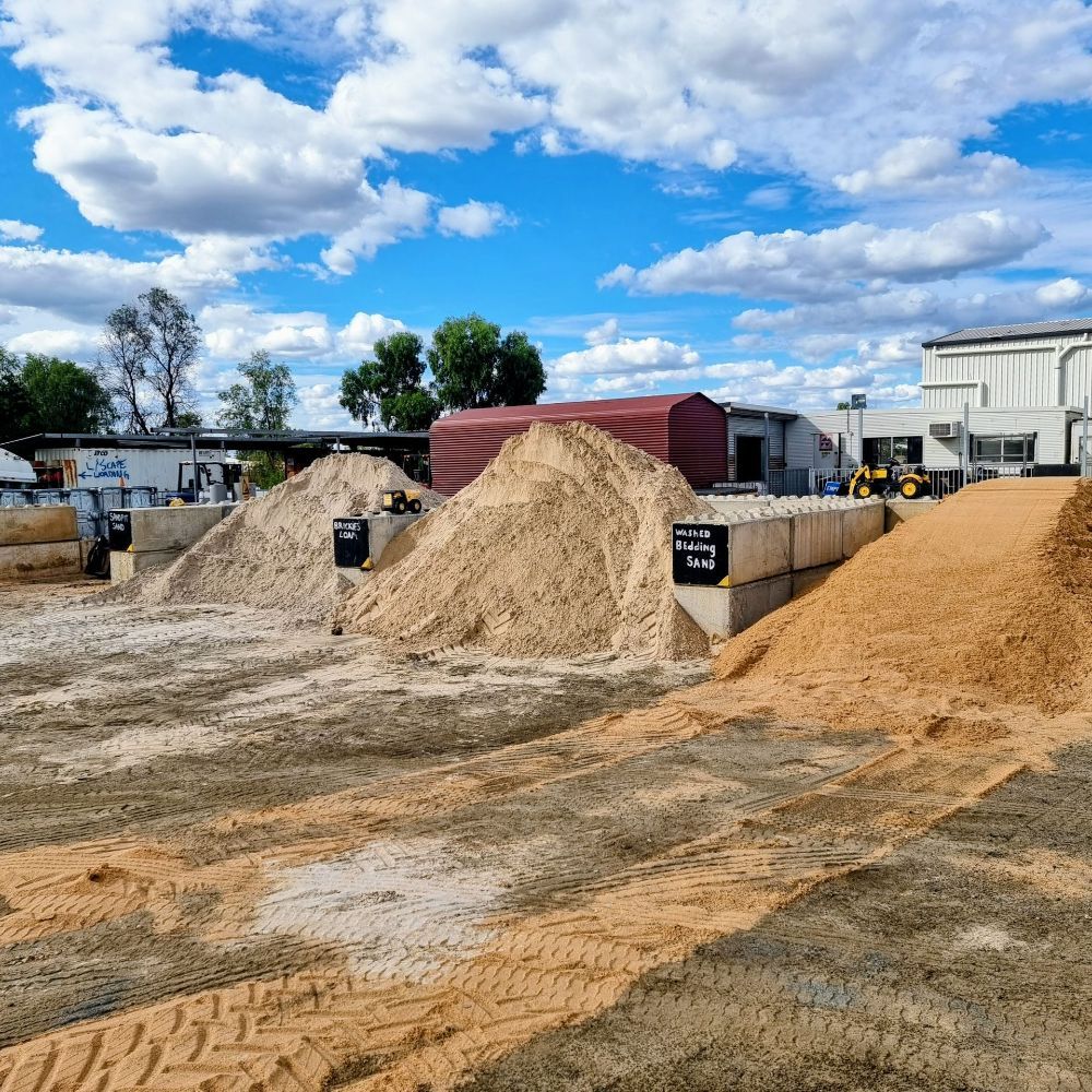 A Stone Wall Surrounded by Flowers and Plants in a Garden — Beehive Property Maintenance in Dysart, QLD