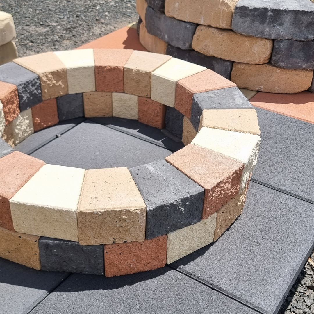 A Row of Square Tiles Sitting on Top of a Pile of Rocks — Beehive Property Maintenance in Emerald, QLD
