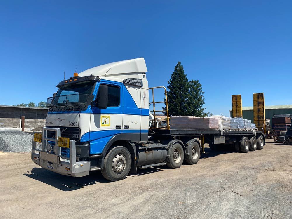 A Blue and White Semi Truck is Parked in a Parking Lot — Beehive Property Maintenance in Emerald, QLD