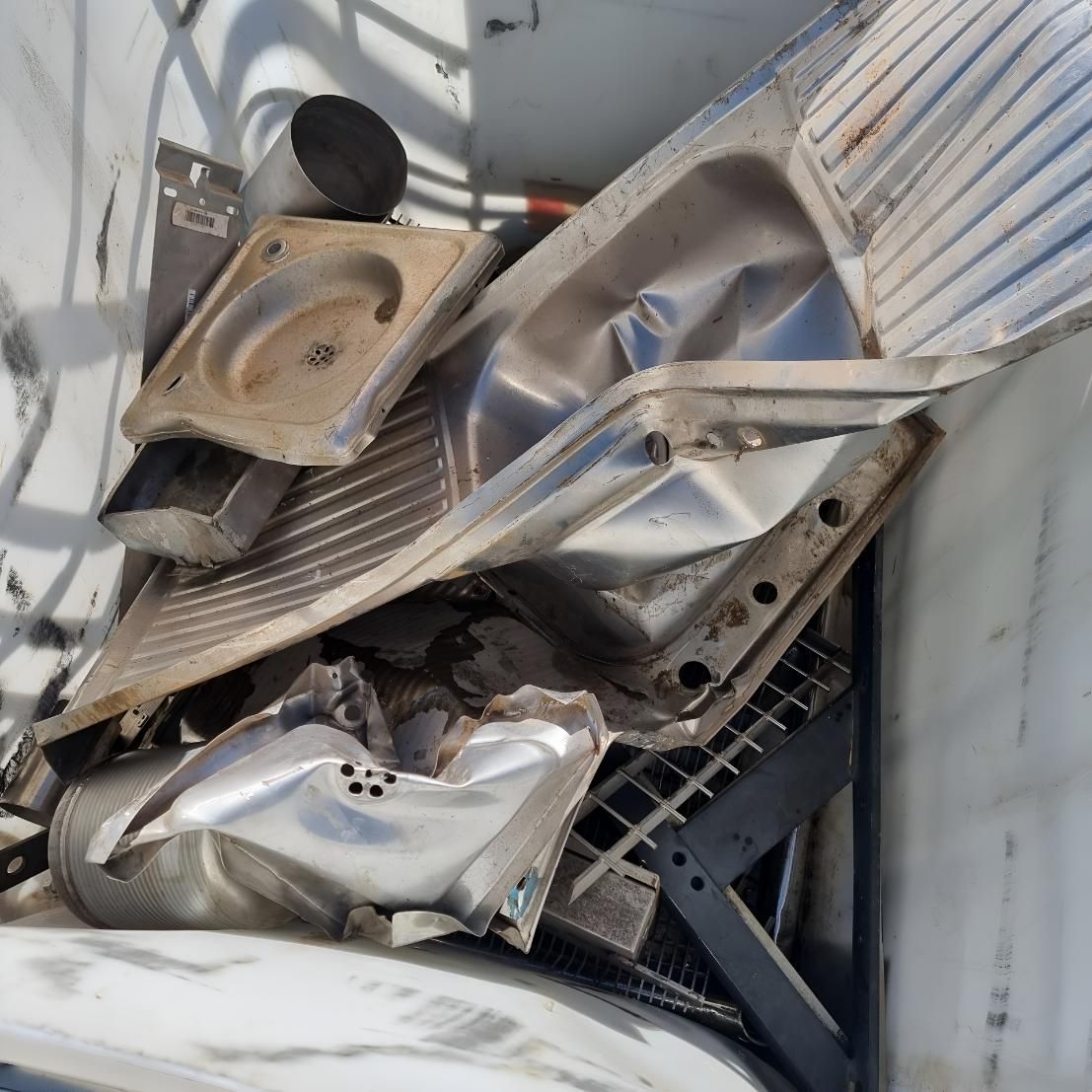 Pile of Junk is Sitting on Top of a White Surface — Beehive Property Maintenance in Moranbah, QLD