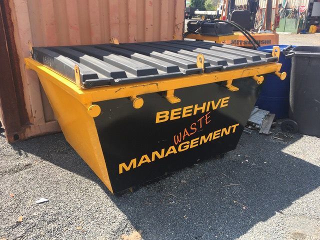 A Black and Yellow Dumpster That Says Beehive Waste Management — Beehive Property Maintenance in Emerald, QLD