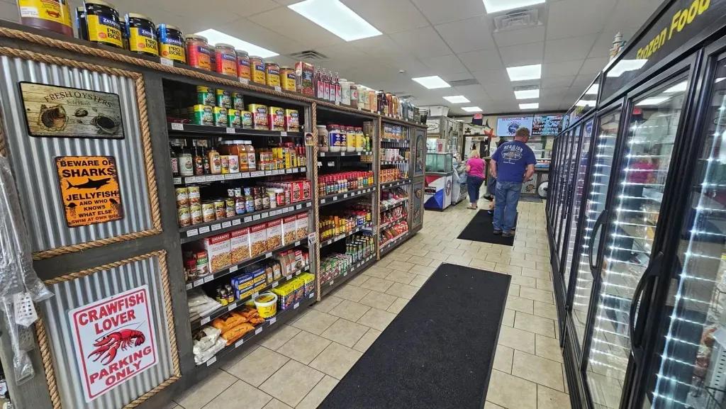 A man is walking down the aisle of a grocery store.