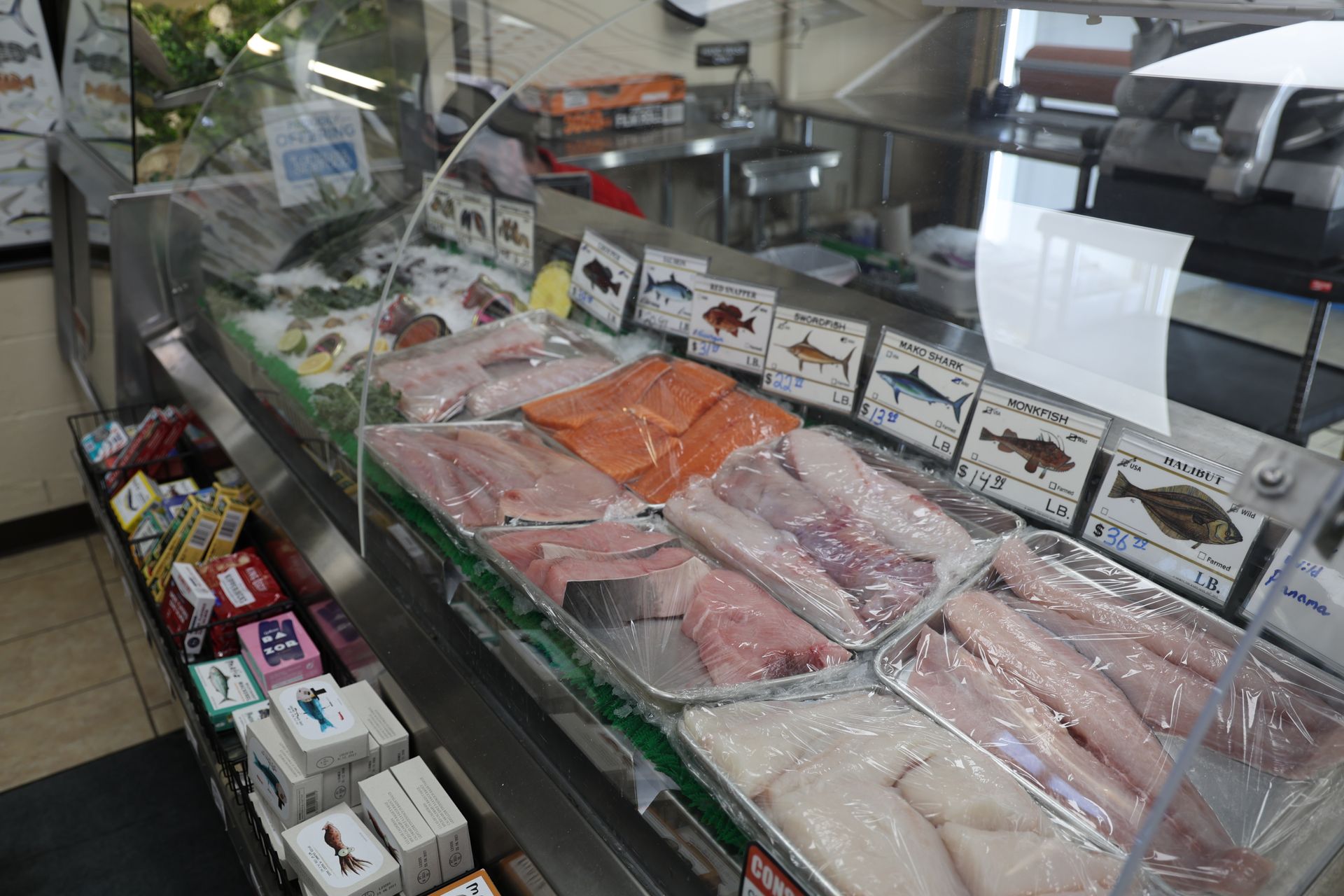 A display case filled with lots of different types of fish.