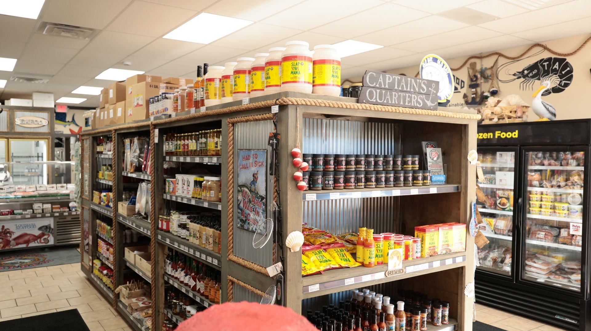 A grocery store filled with lots of shelves and a sign that says captain 's club toss.