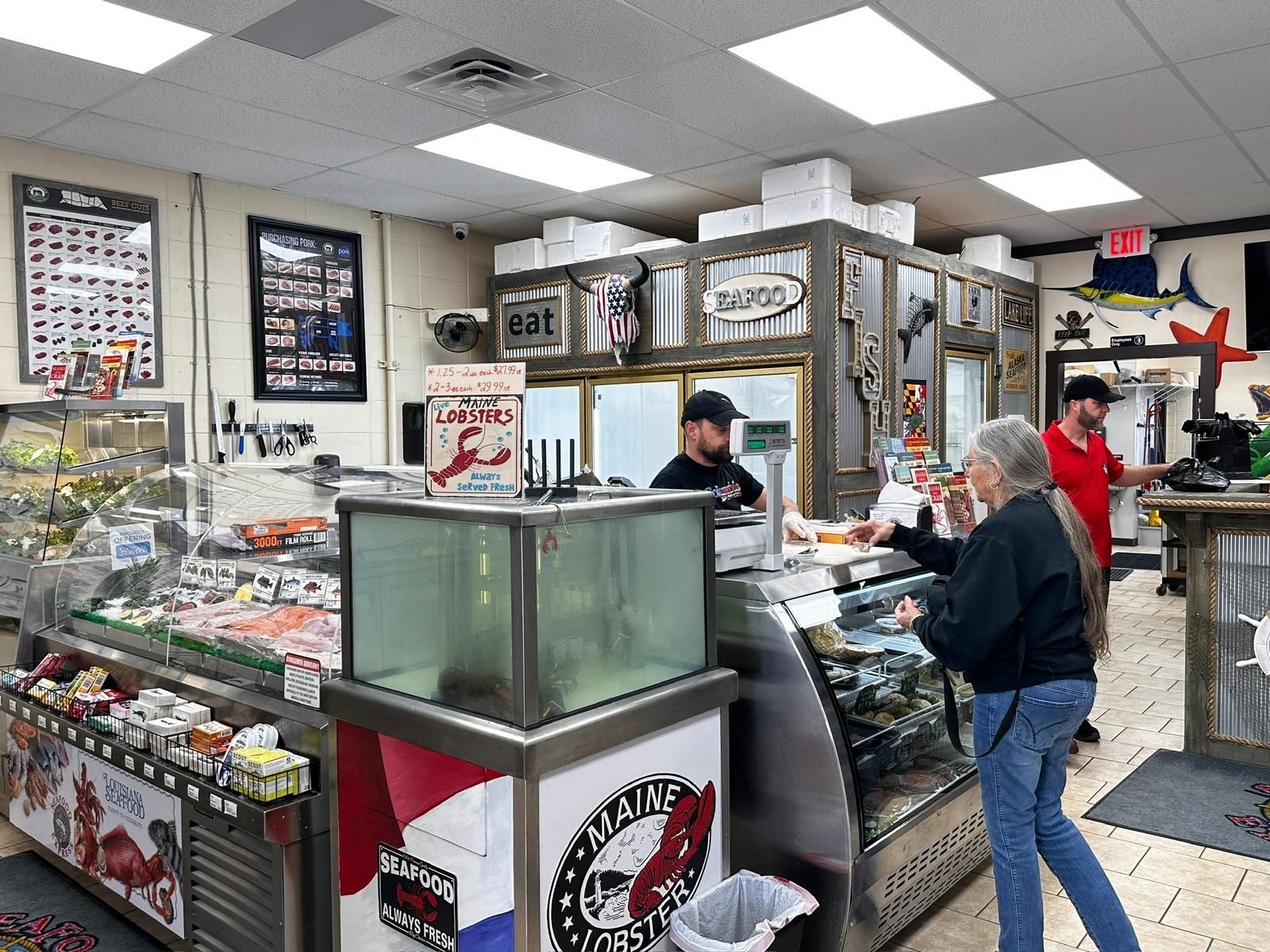 A woman is standing in front of a counter in a restaurant.