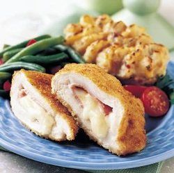 A blue plate topped with chicken cordon bleu and green beans.