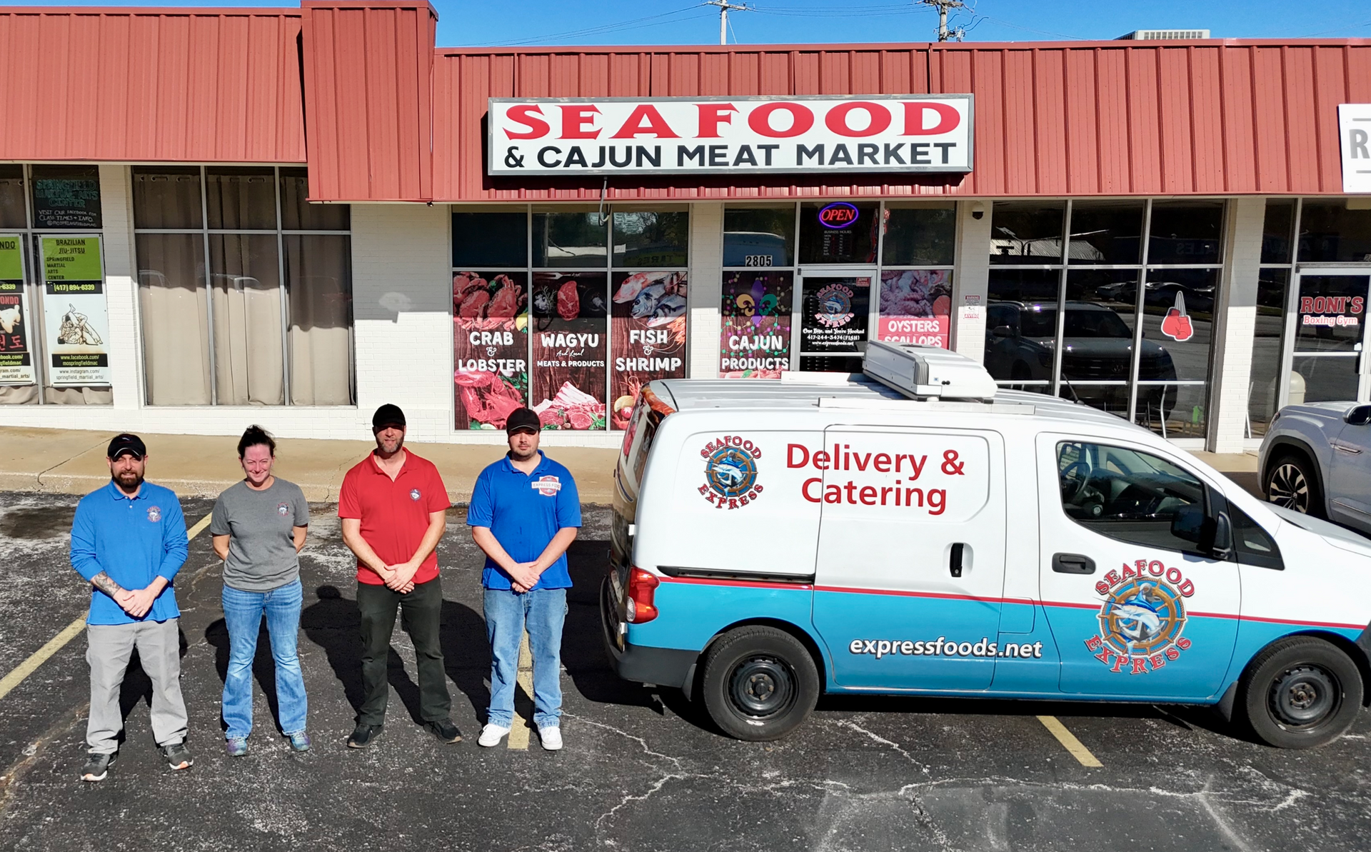 A group of men are standing in front of a seafood and cajun meat market.