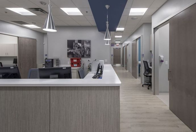 A hospital with a long hallway and a reception desk.