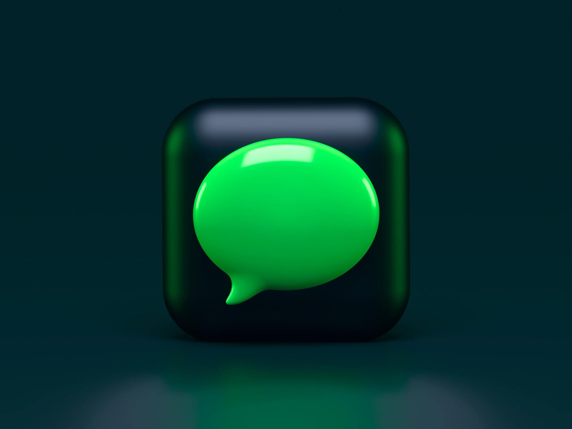 Green speech bubble icon within a black rounded square on a dark green background.