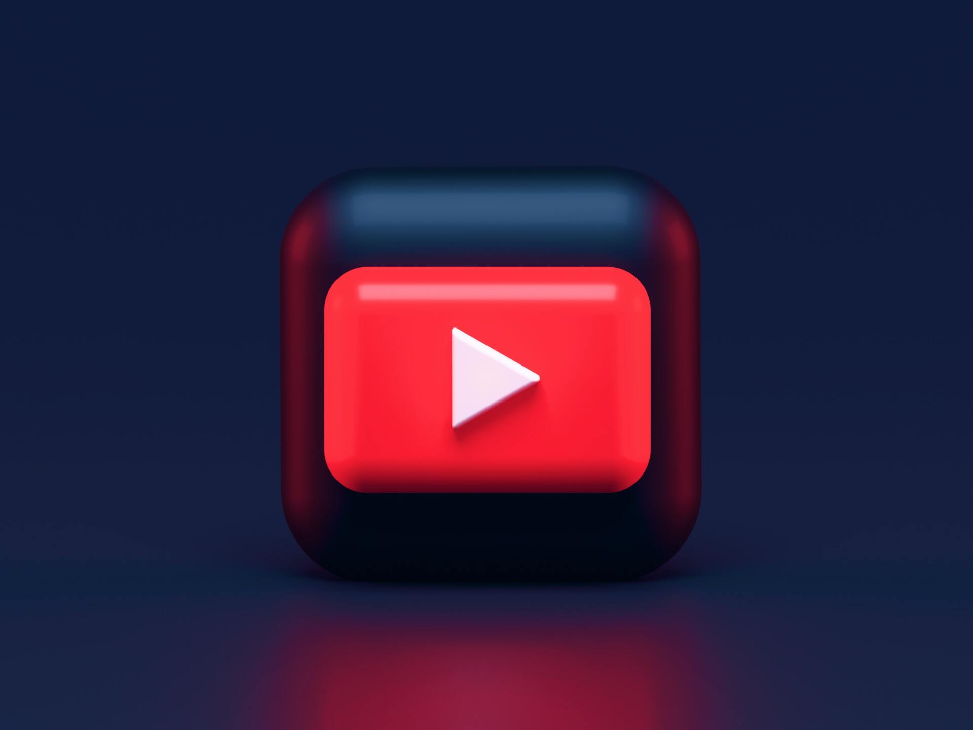 YouTube icon, red play button with white triangle, inside a rounded black square.