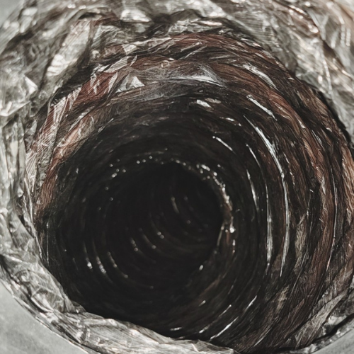 A close up of a duct with a hole in it