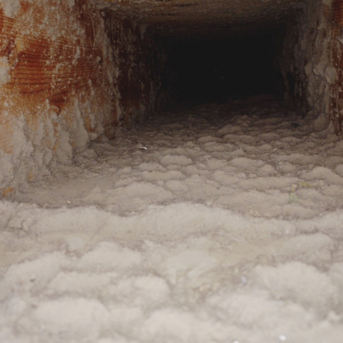 A tunnel filled with a lot of white foam coming out of it.