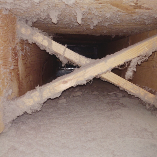 A wooden beam is crossed in the middle of a room