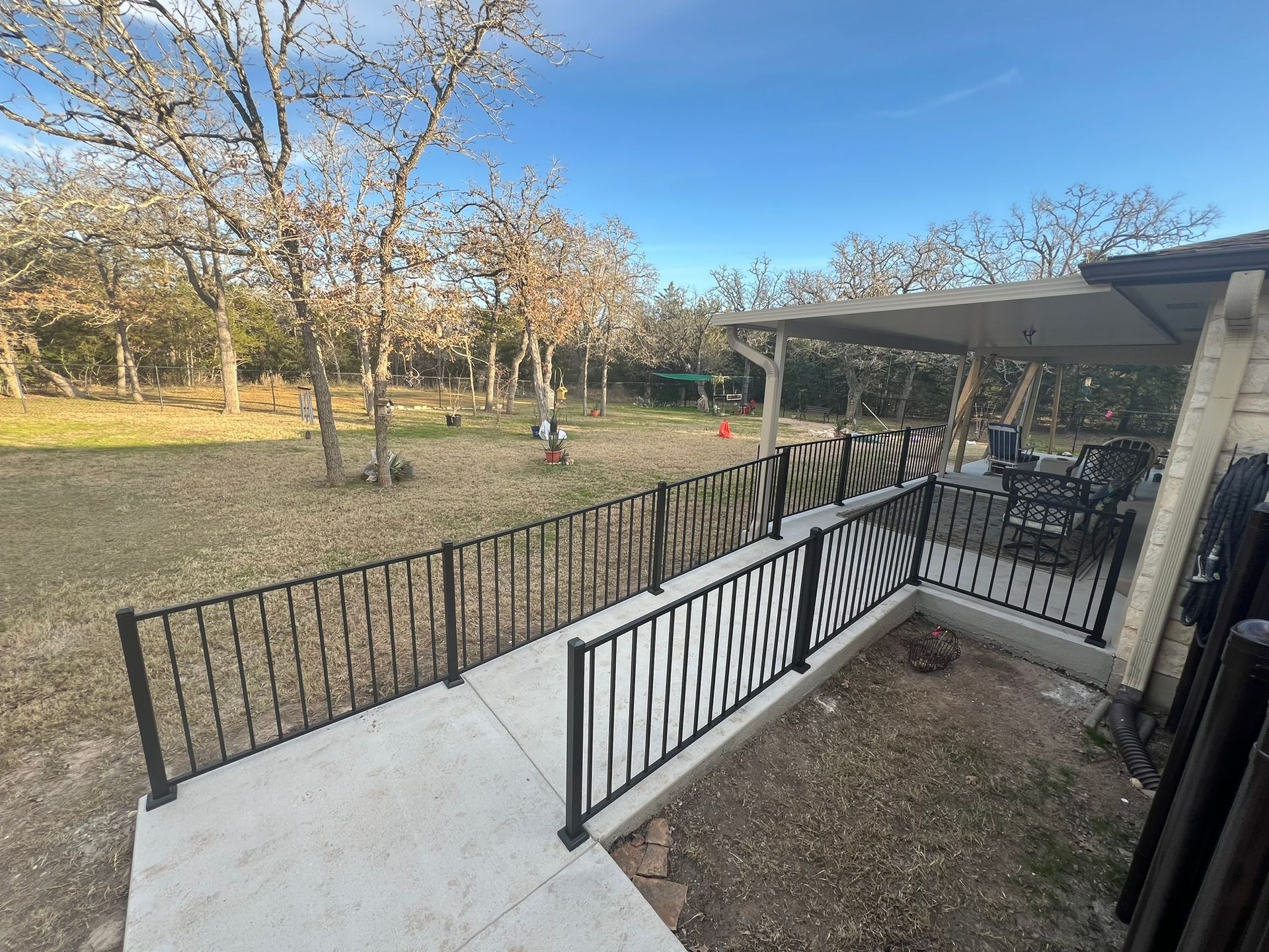 There is a ramp leading to the backyard of a house.