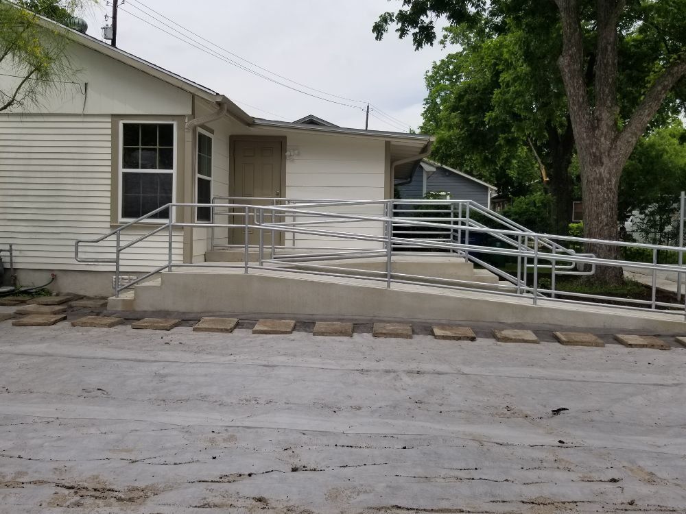 A white house with a ramp in front of it