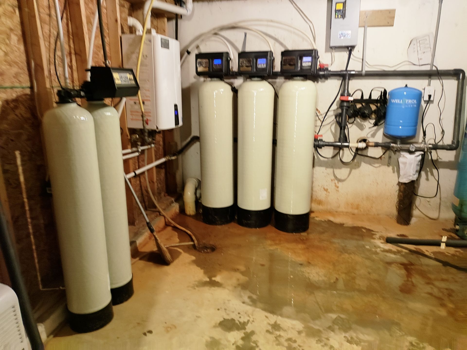 A Row of Water Filters in a Basement — Union City, IN — Wiley Water Systems