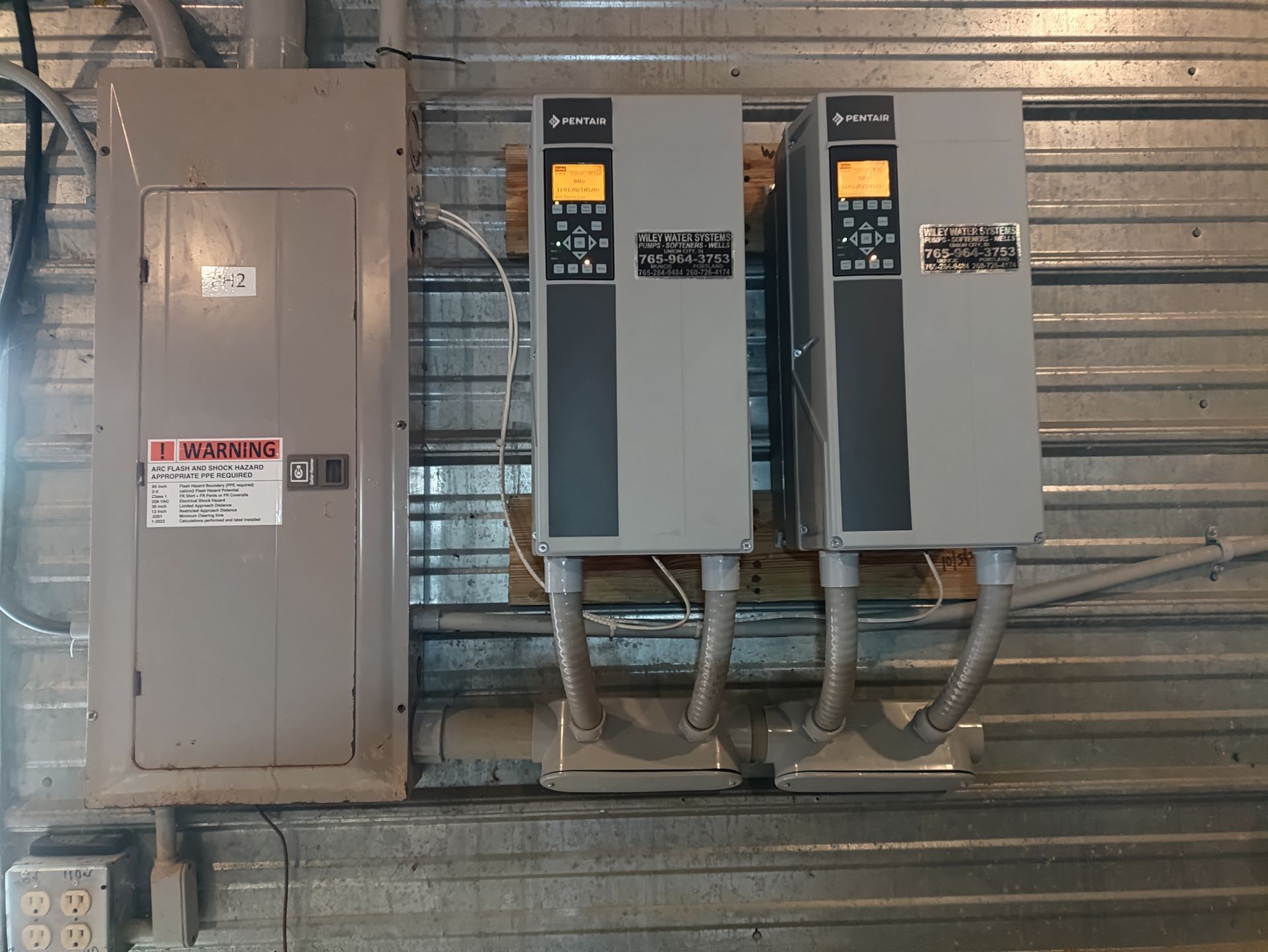 Two Electrical Boxes are Hanging on a Metal Wall — Union City, IN — Wiley Water Systems