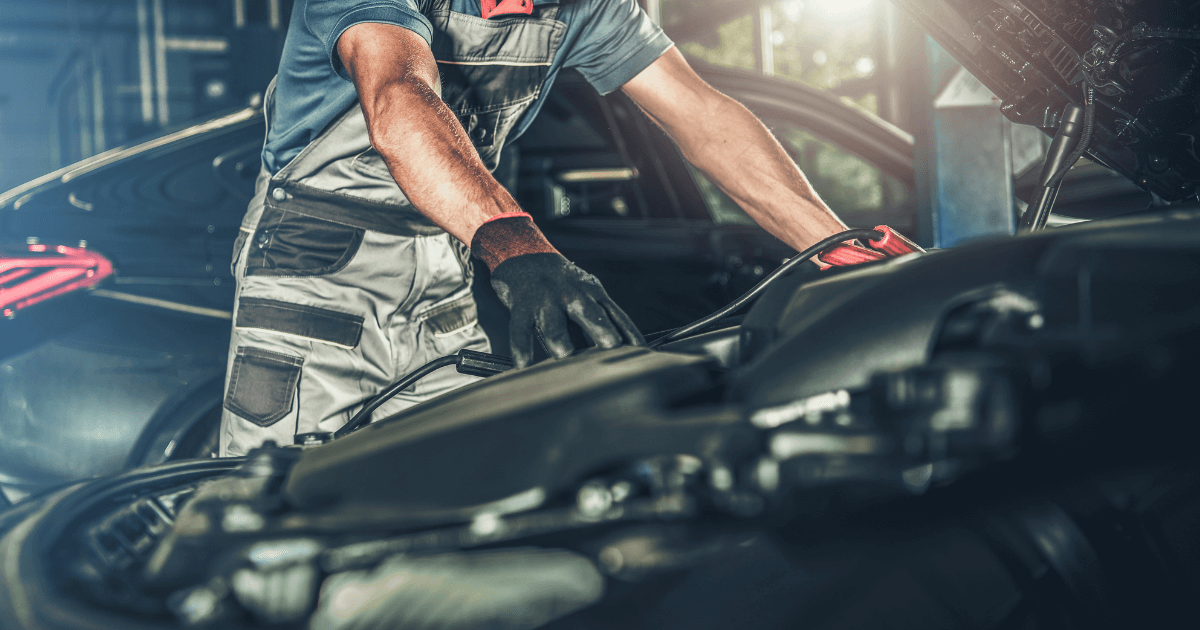 a mechanic looking under the hood of a car