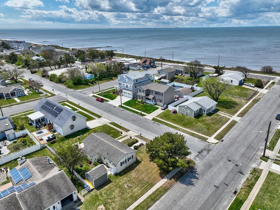 An aerial view of a residential area next to the ocean.