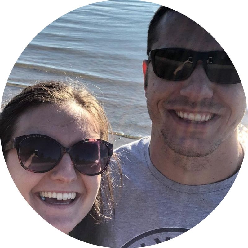 A man and a woman wearing sunglasses are smiling for a picture