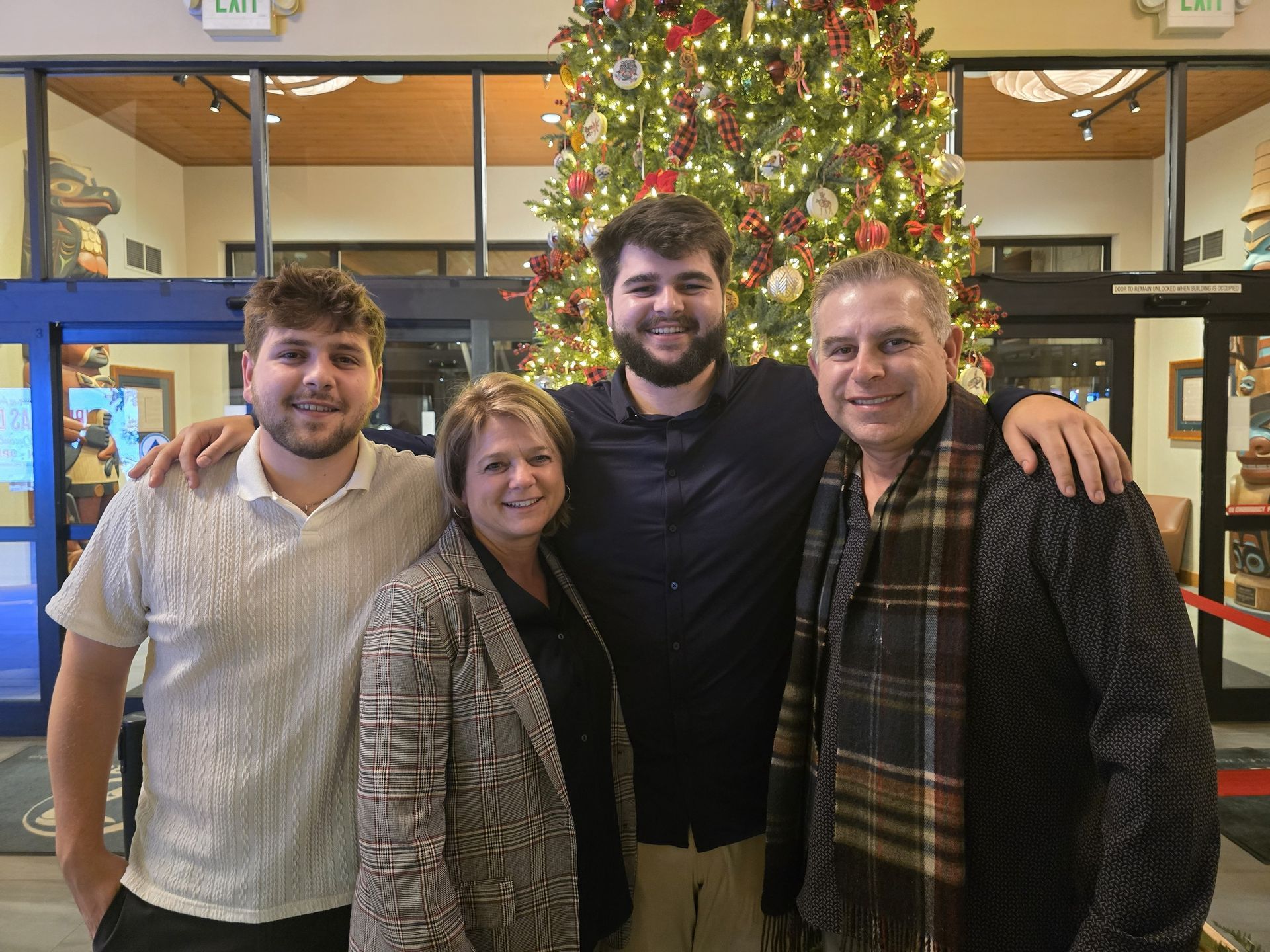 A group of people are posing for a picture in front of a building.