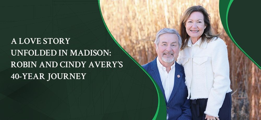 A man and a woman are standing next to each other in a field.