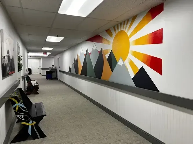 A long hallway with mountains painted on the wall