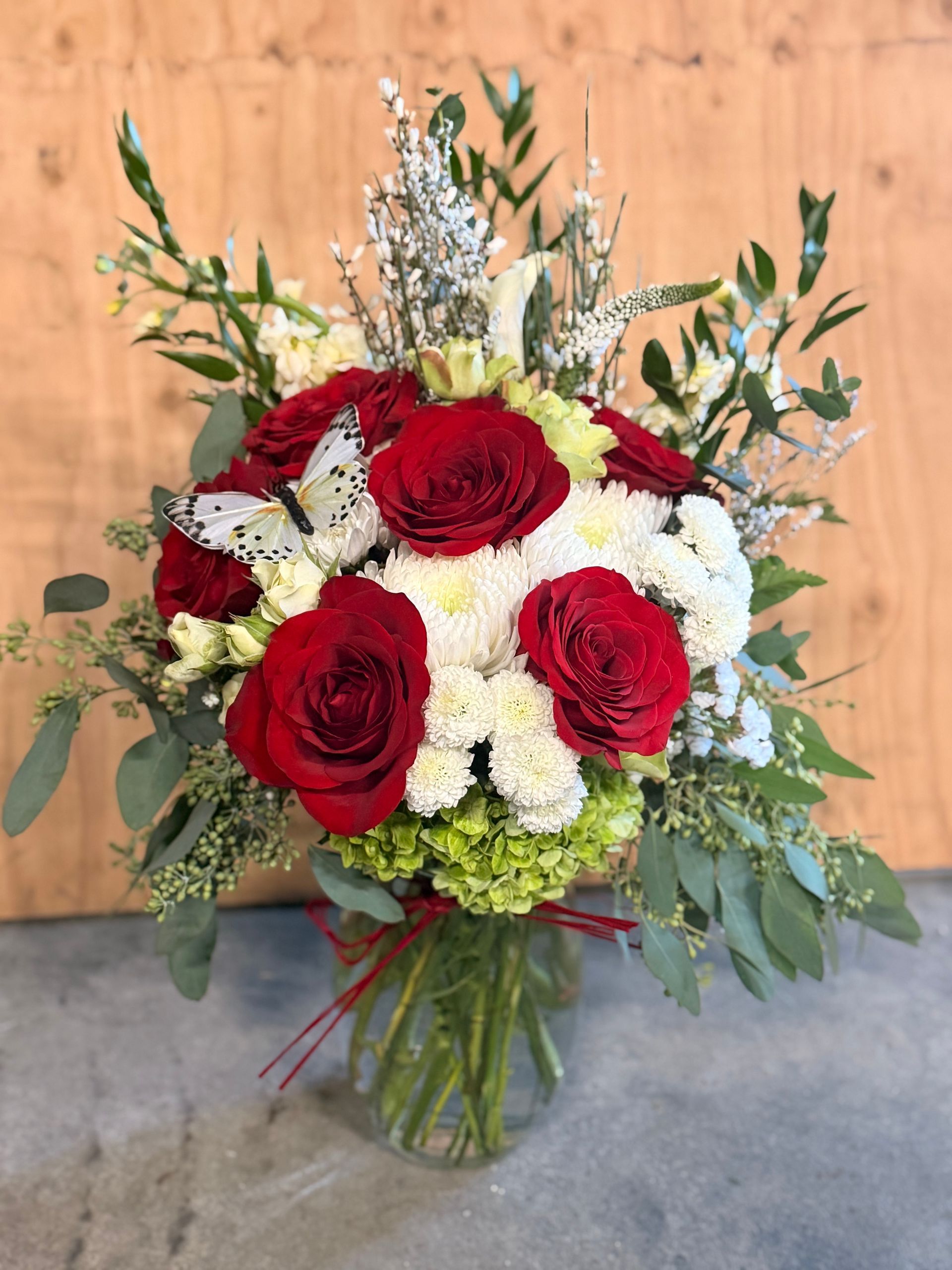 Bouquet of pink and purple flowers rests on concrete blocks in an outdoor setting.