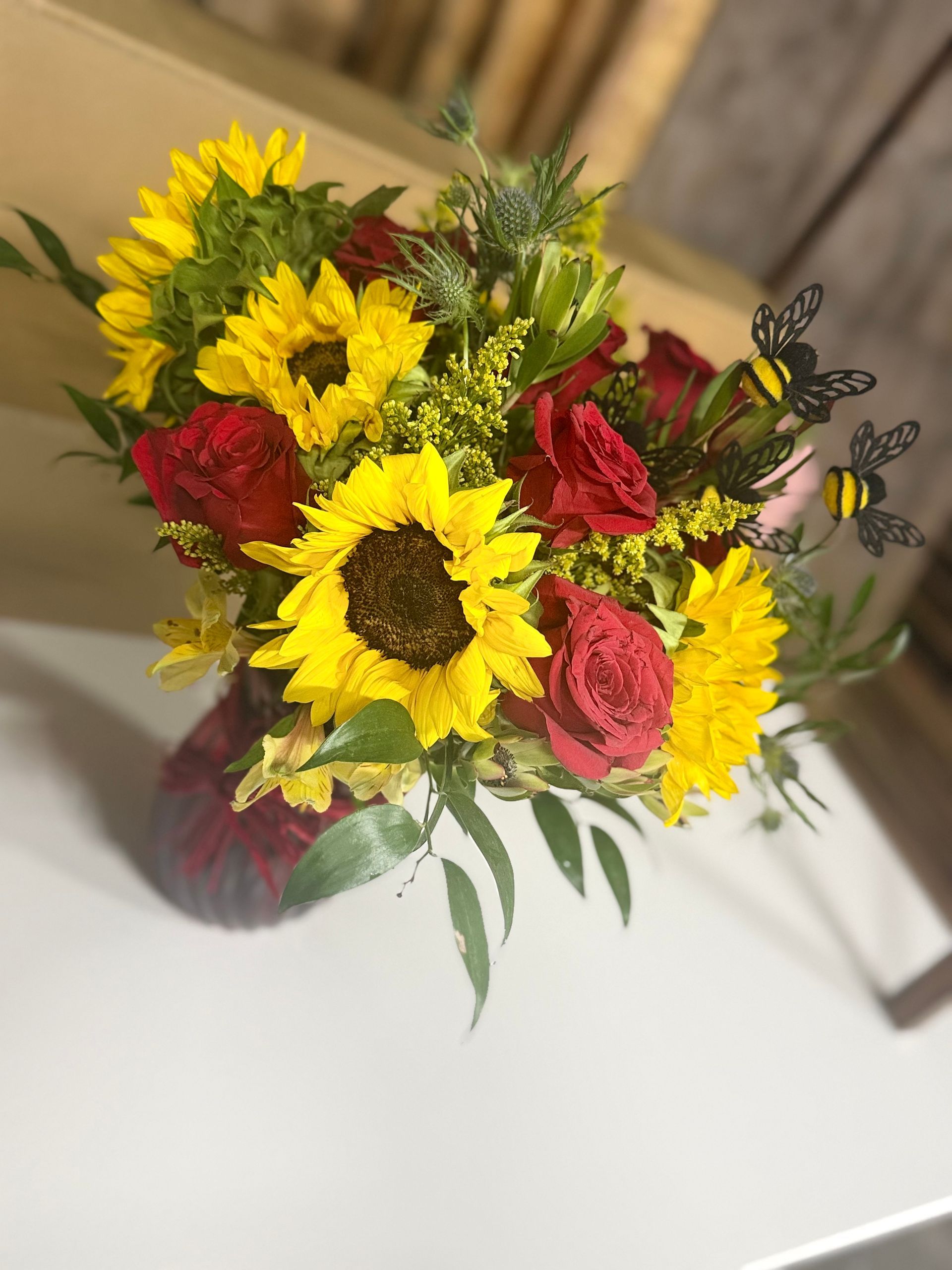 Bouquet of bright pink and other purple flowers in a glass vase.