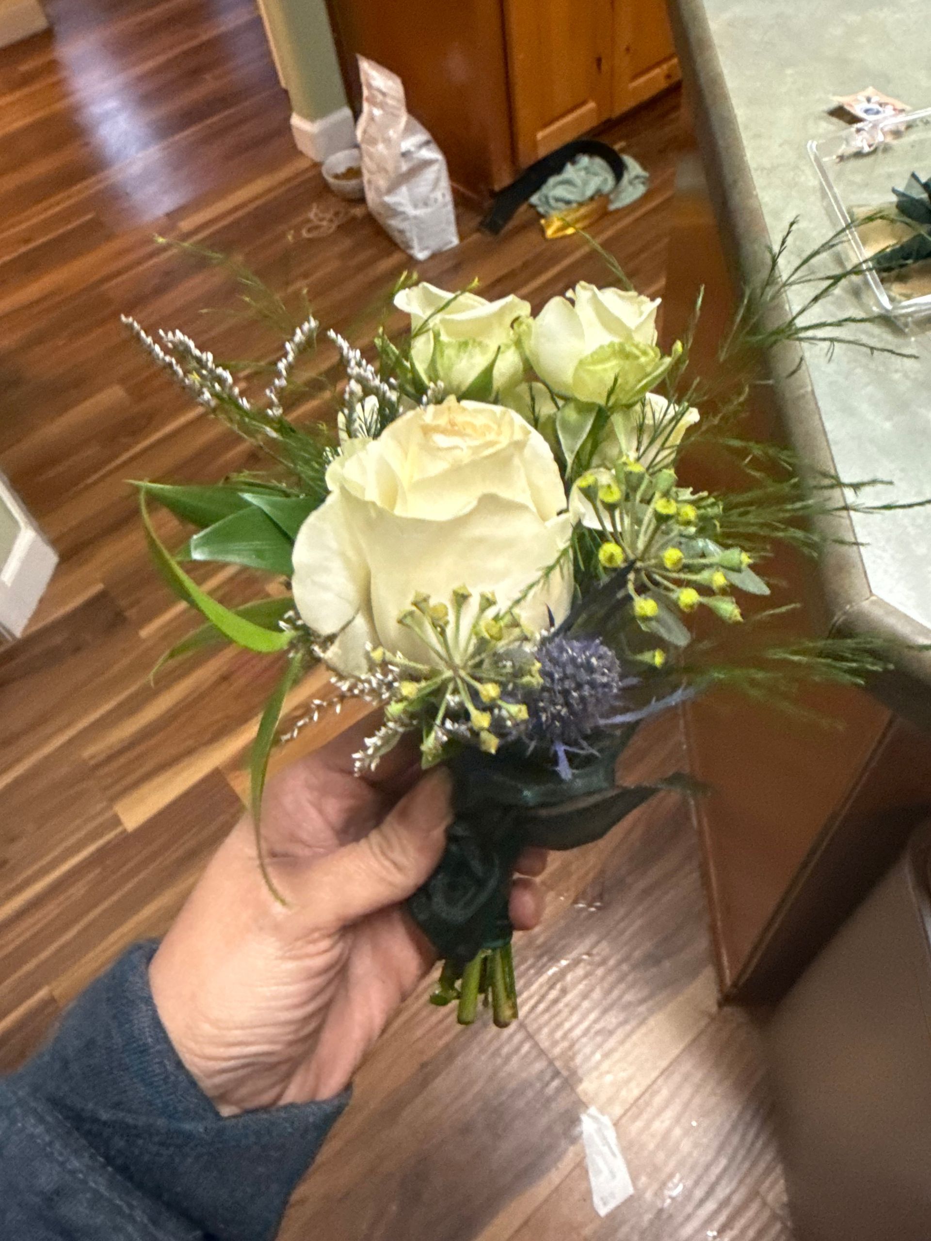 Happy birthday card in a bouquet of pink and peach flowers with pink ribbon.
