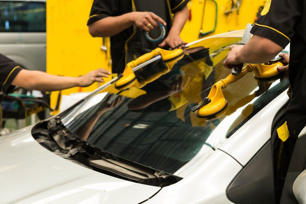Repairman Is Repairing Windshield Of The Car — Hervey Bay Mobile Windscreens In Pialba Queensland