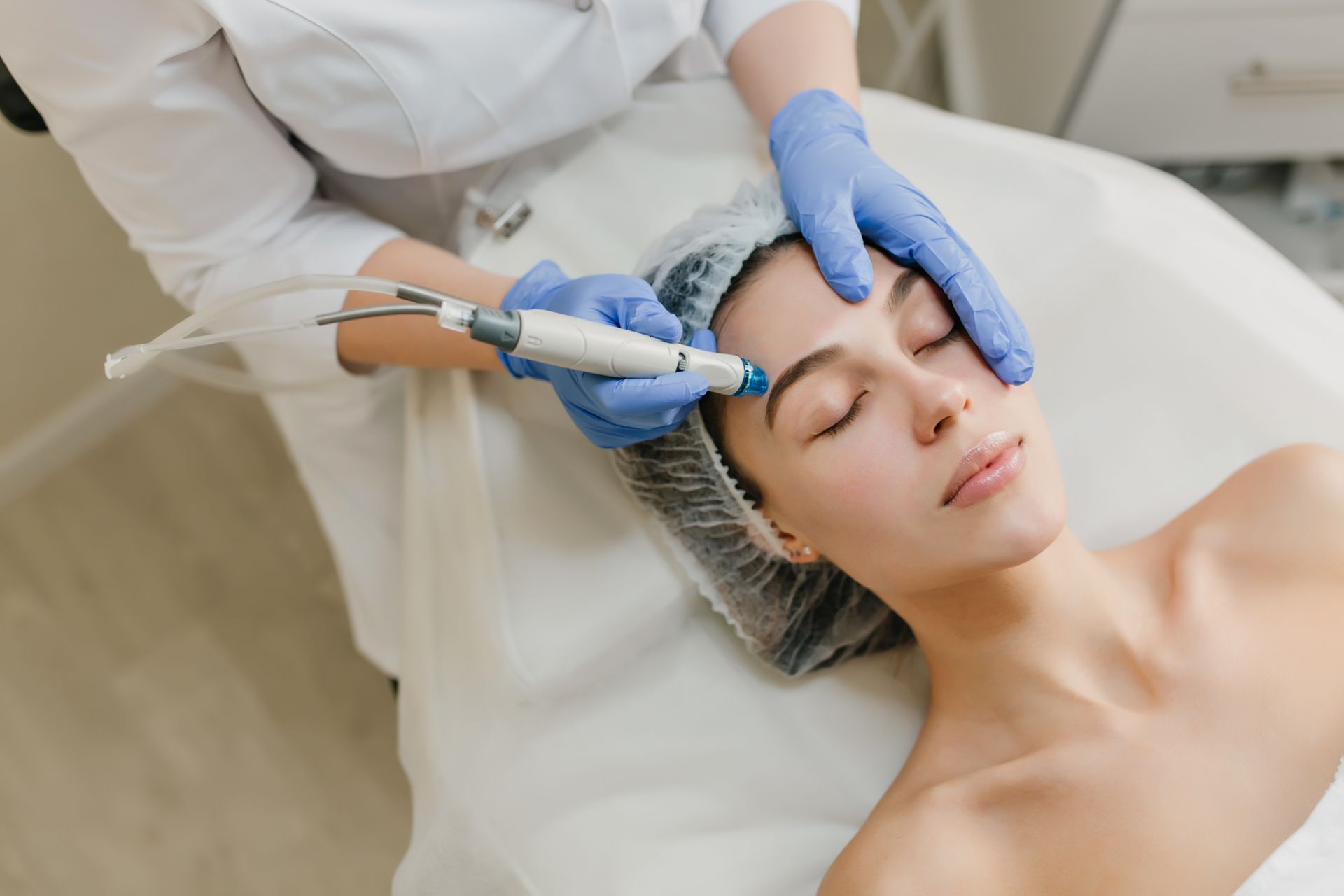 A woman is getting a facial treatment in a beauty salon.