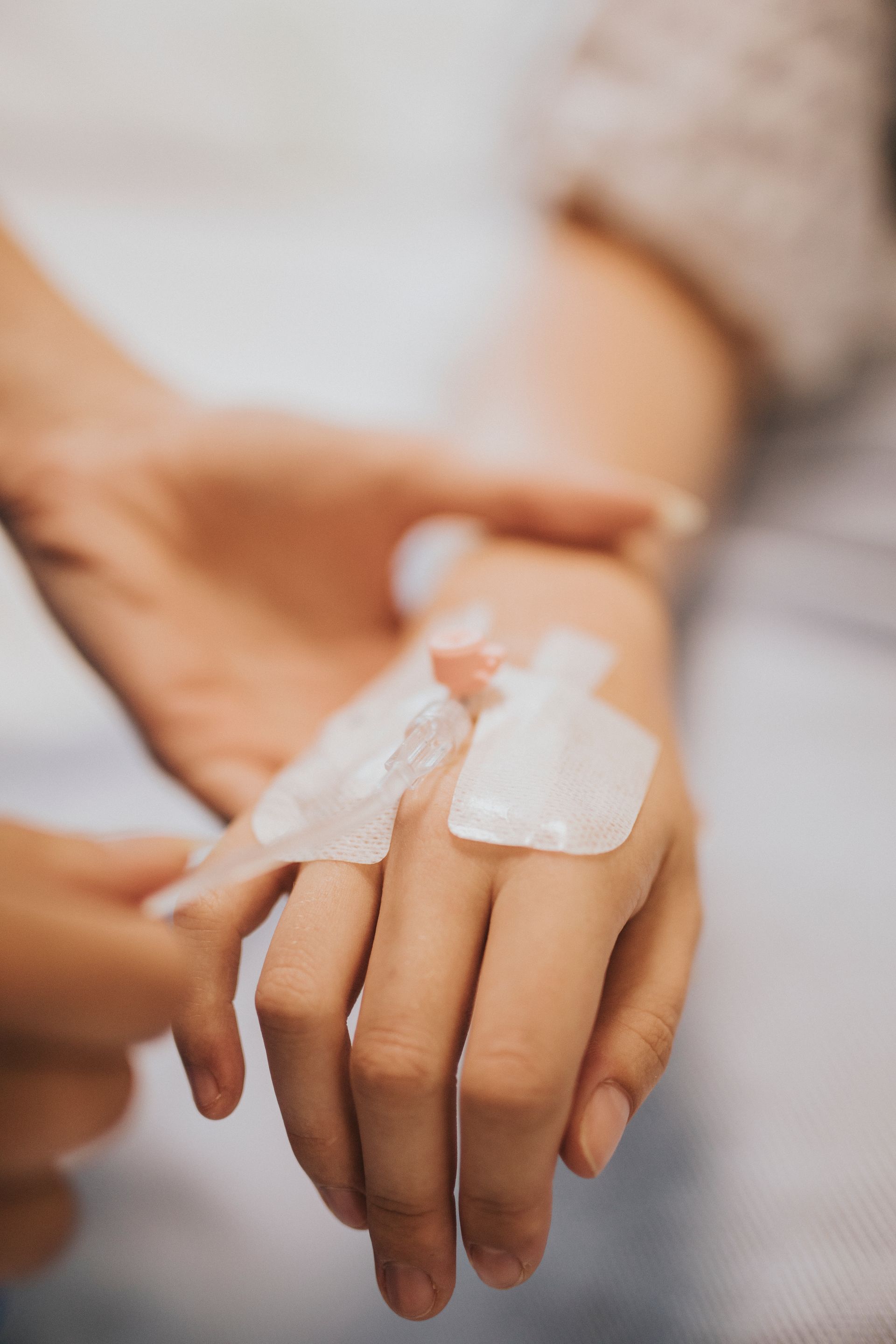 A person is getting an iv in their hand.